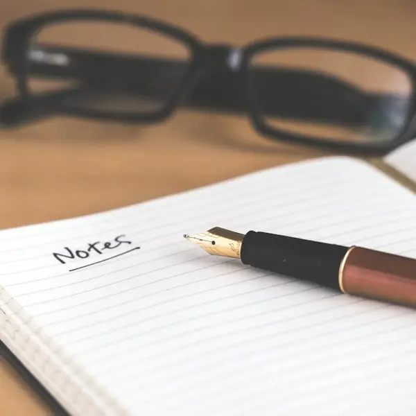 Ruled notebook and pen